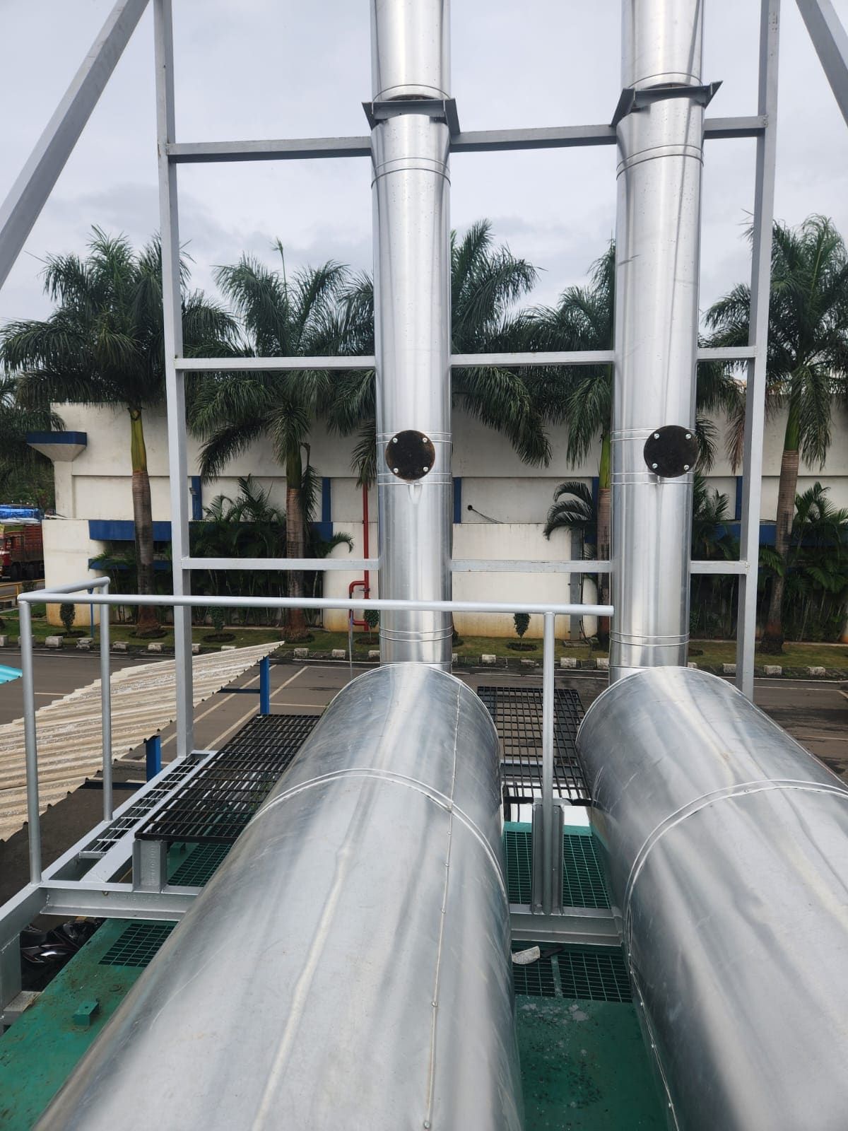 Twin insulated exhaust stacks rising through galvanised support steel