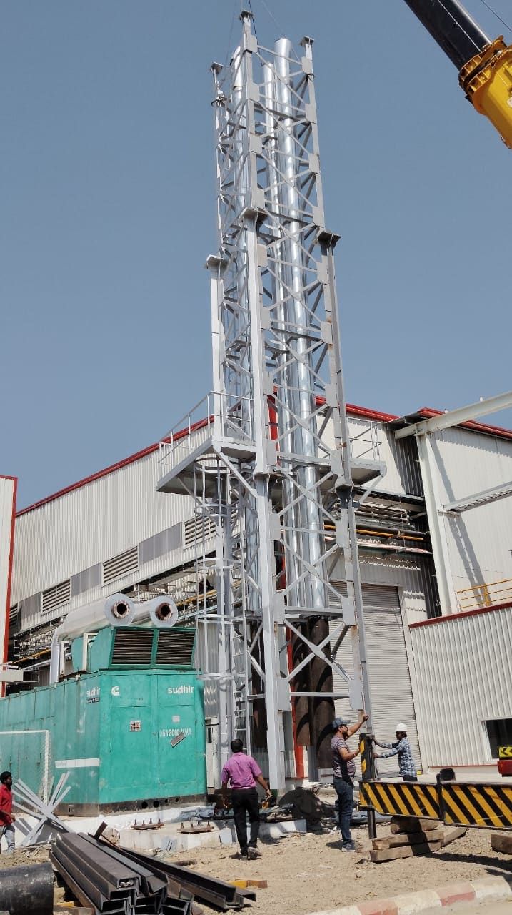 A 30 metre lattice stack being erected by mobile crane at Chakan